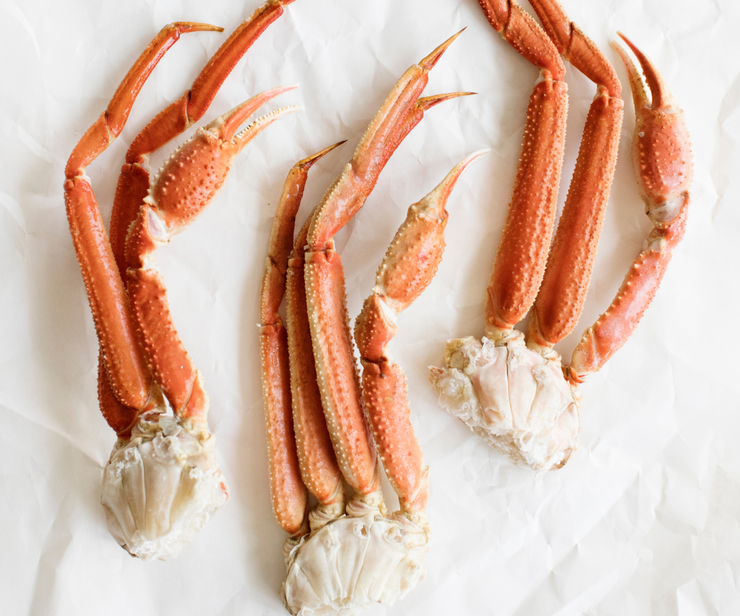 snow crab clusters on white butcher paper