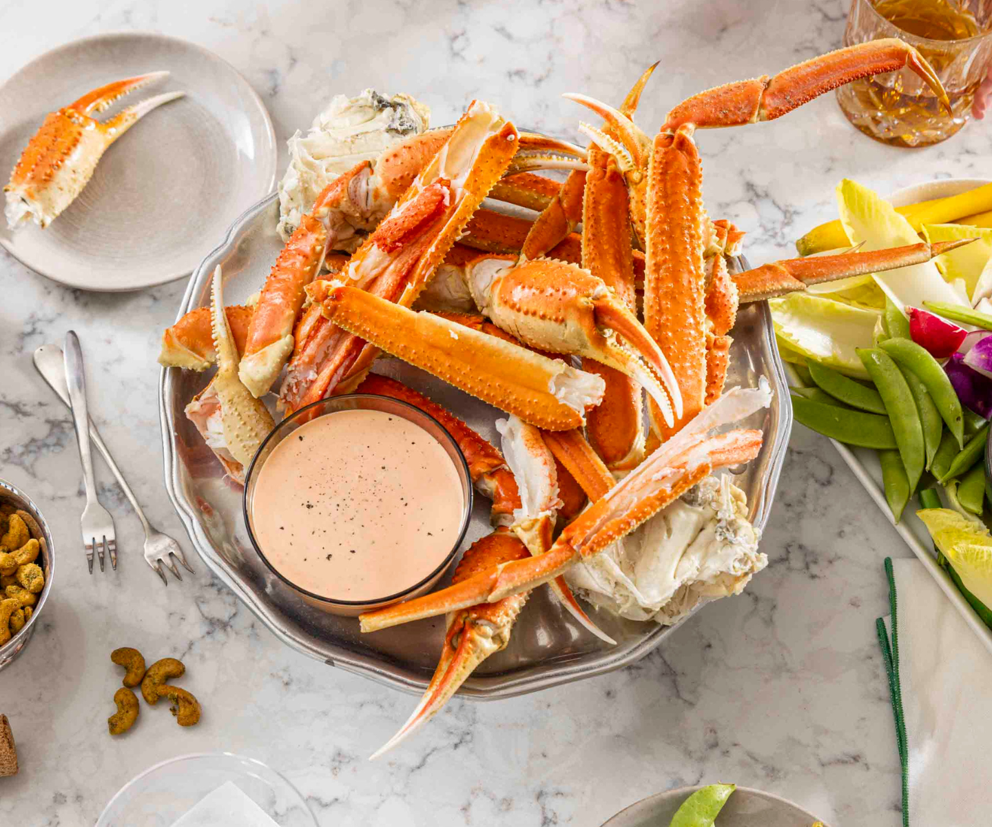 Snow crab legs on a platter with a dipping sauce