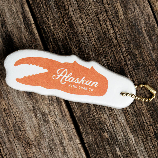 Floatie Keychain with orange crab claw and Alaskan King Crab Co. Logo