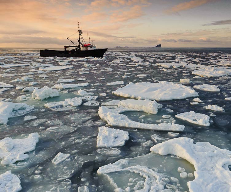 Fishing boat on icy waters.