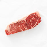 Raw steak with marbling on a white background