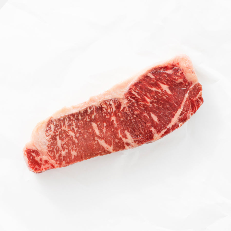 Raw steak with marbling on a white background