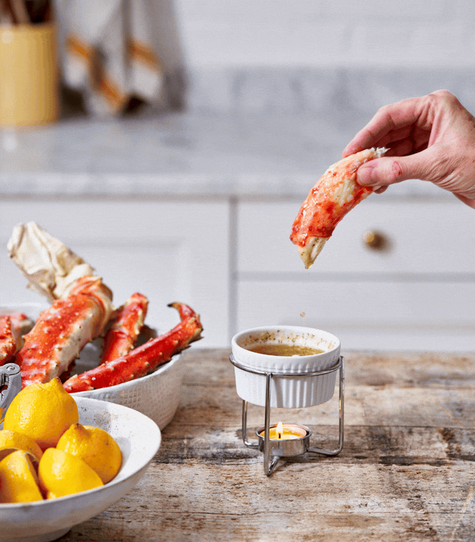 dipping king crab meat in butter