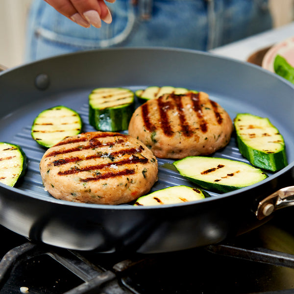 Grilled salmon burgers and zucchini on a pan