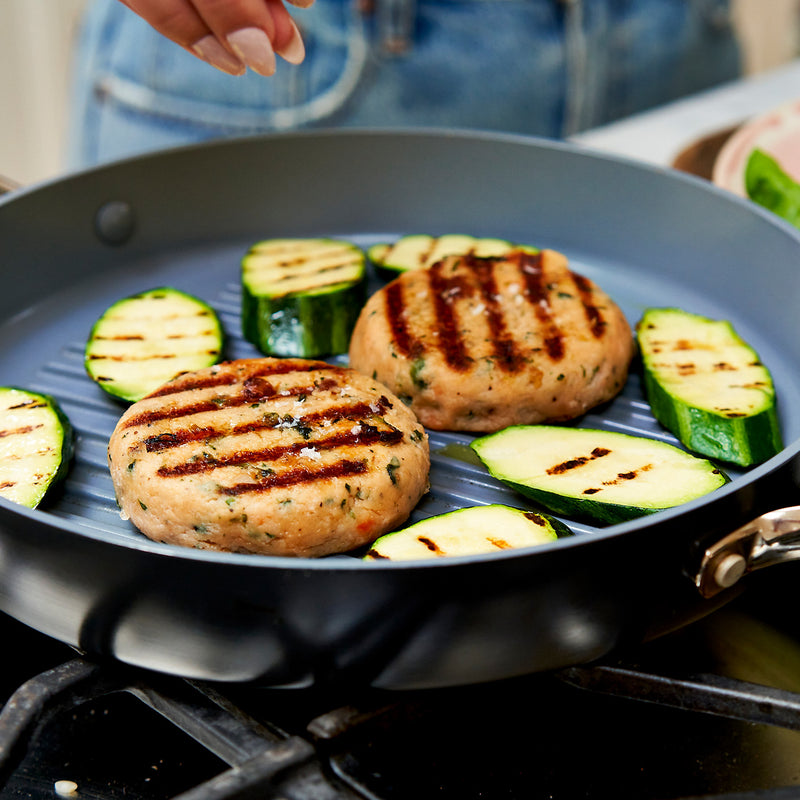 Grilled salmon burgers and zucchini on a pan