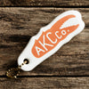 Floatie Keychain with orange crab claw and AKC Co. Logo