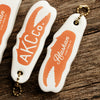 Floatie Keychain showing front and back with orange crab claw and Alaskan King Crab Co. Logo