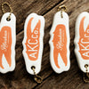 Four lloatie keychains with orange crab claw and Alaskan King Crab Co. Logo