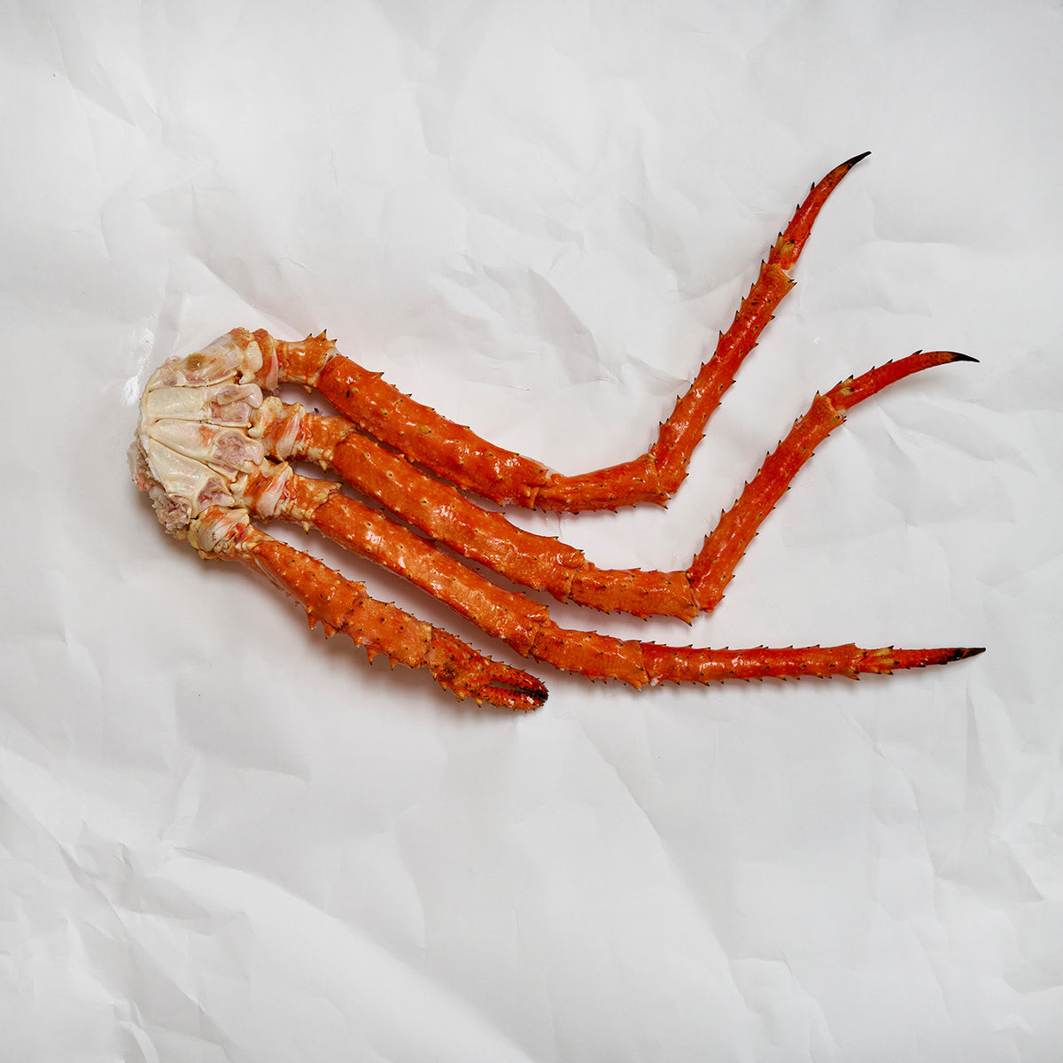 Golden king crab cluster on parchment paper