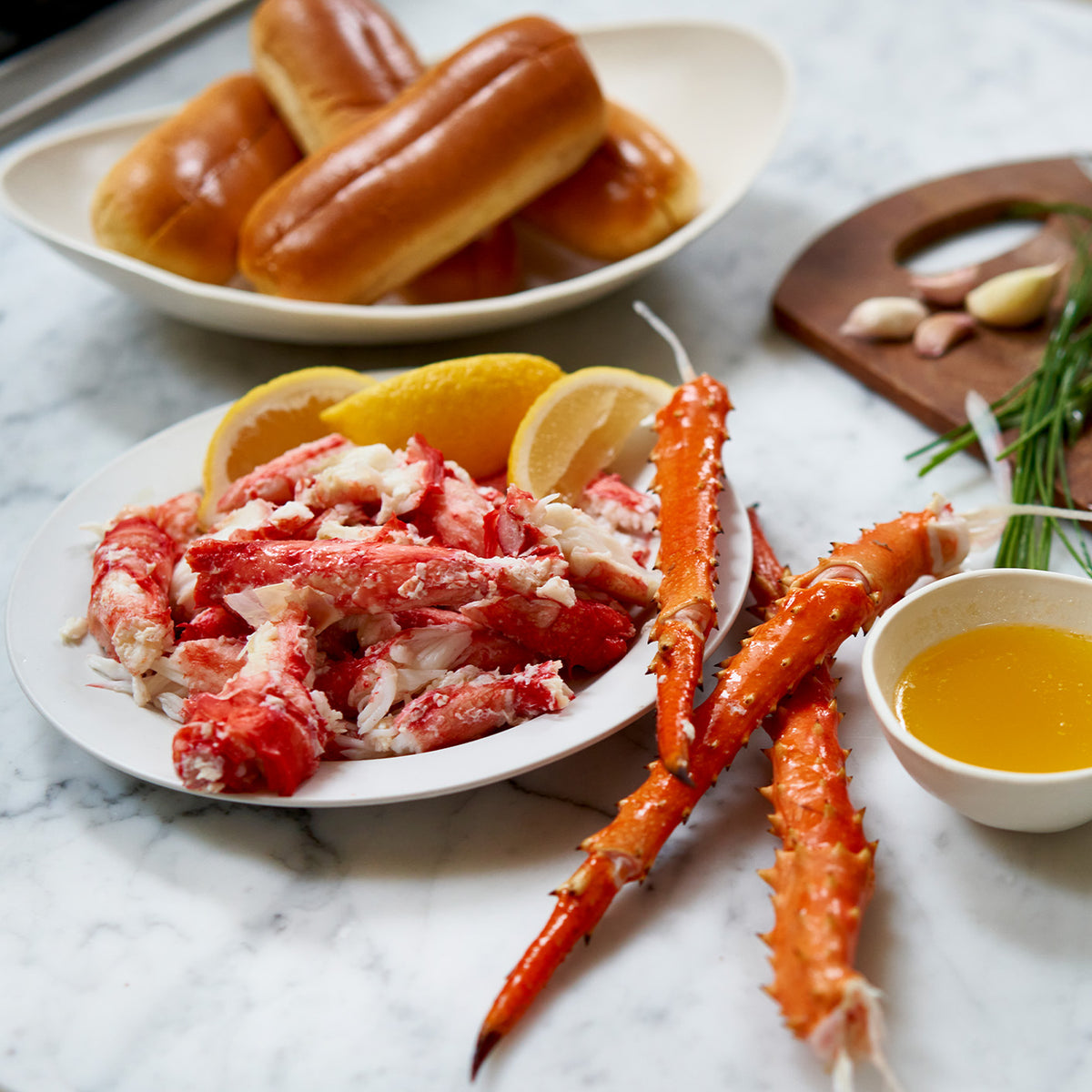 Golden king crab cluster meat on a plate with butter and lemon 
