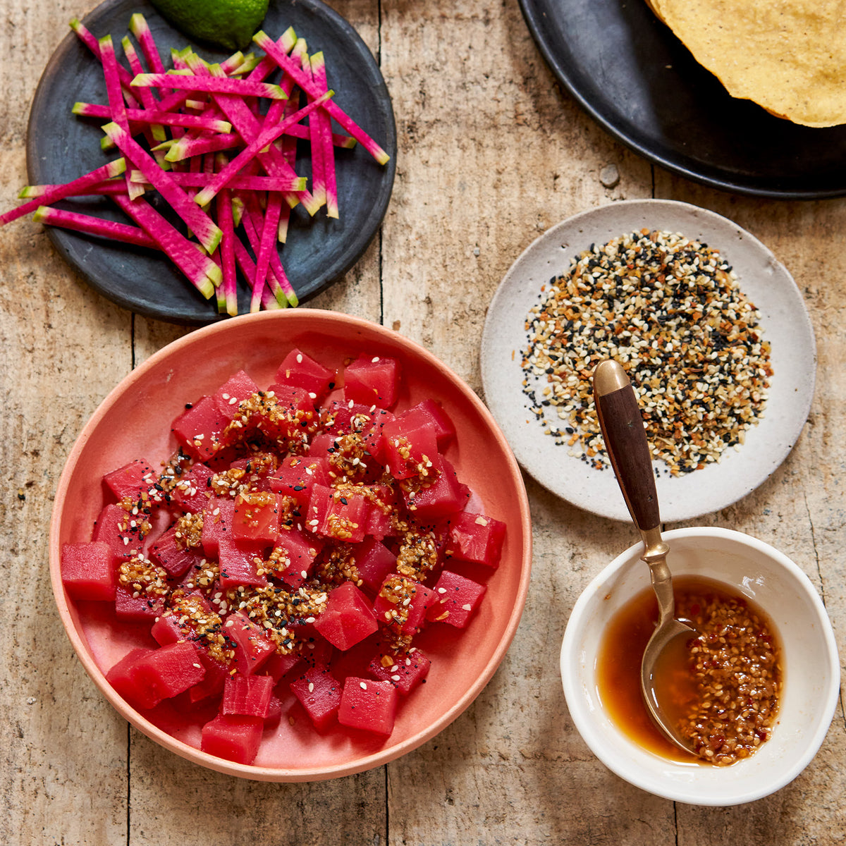 Ahi tuna, wasabi sauce, and sesame seeds in bowls 