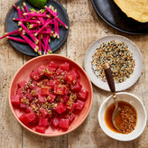 Ahi tuna, wasabi sauce, and sesame seeds in bowls 