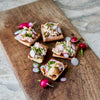 Smoked Steelhead Trout salad served on bread, topped with Radish 