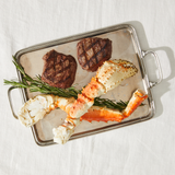 Tray with grilled steak and king crab leg on a white background