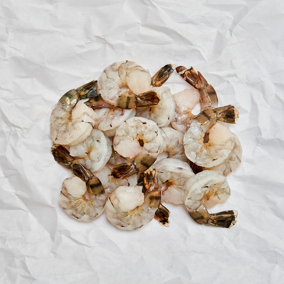raw tiger shrimp on butcher paper