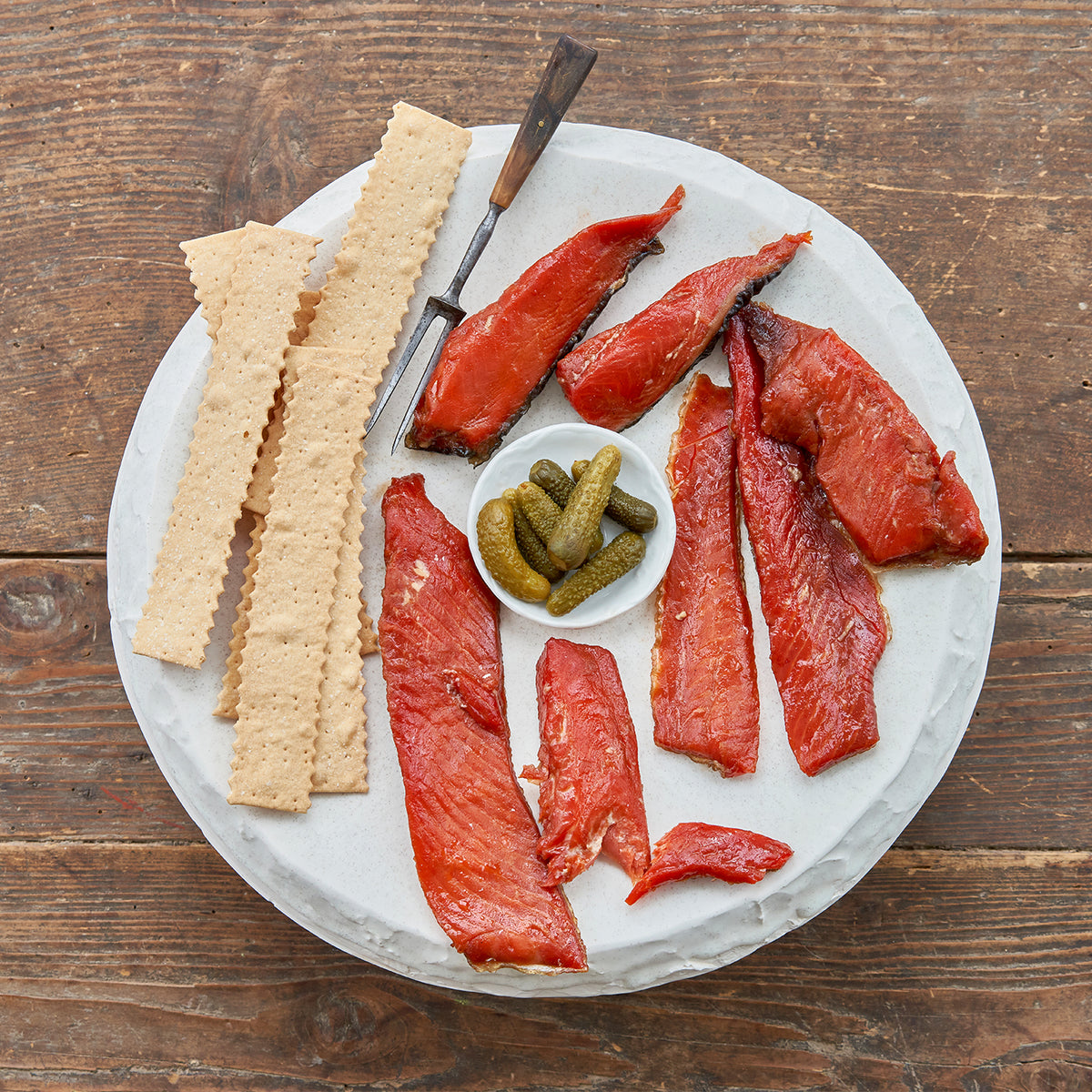 Sockeye Salmon Candy Strips served with crackers and pickles